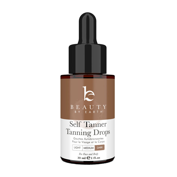 The Beauty by Earth Tanning Drops dropper bottle, labeled with light, medium, and dark gradient indicators, contains 30 ml (1 fl oz) for face and body. It offers a natural-looking tan with organic ingredients.