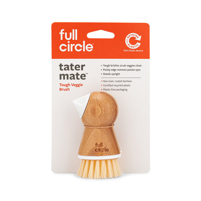 The Tater Mate - Eye-Removing Potato Scrubber by Full Circle is a wooden brush with a white top and bamboo handle, designed for meal prep. Plastic-free, its perfect for cleaning vegetables and includes an eye remover specifically for potatoes.