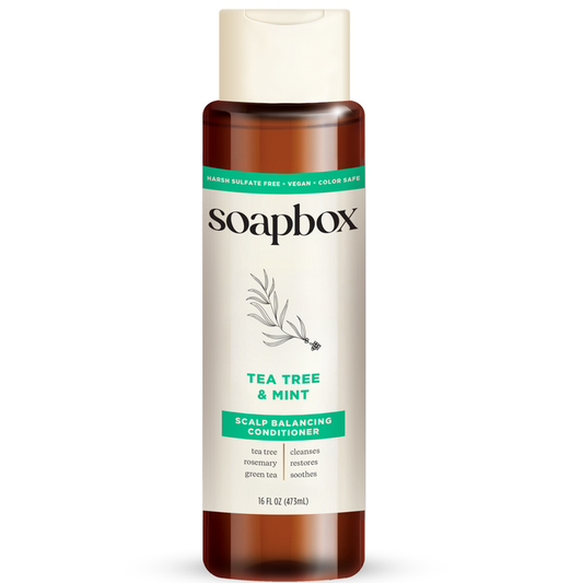 The 16 fl oz (473 ml) brown bottle of Soapbox Tea Tree & Mint Scalp Balancing Conditioner offers lightweight hydration, is sulfate-free, vegan, and color-safe. Featuring tea tree oil, rosemary, and green tea ingredients.