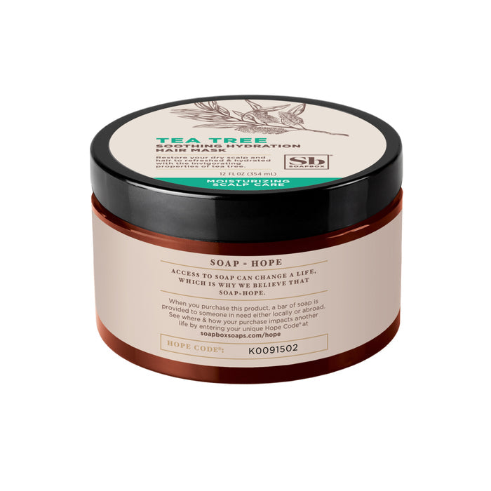 The Tea Tree Soothing Hydration Hair Mask by Soapbox comes in a round container with a black lid and botanical illustration. It includes soap=hope and a hope code. This 12 fl oz (355 mL) mask hydrates and nourishes, ideal for revitalizing dry scalps.