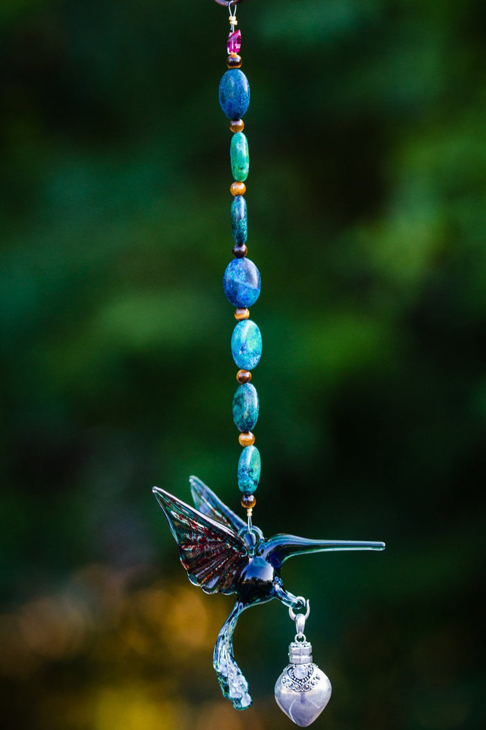 Teal hummingbird glass ornament with turquoise and tiger's eye beads and a silver keepsake urn pendant