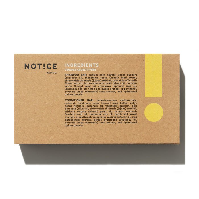A brown package labeled NOT!CE Hair Co features The Balancer Travel Set, a plastic-free, vegan, and cruelty-free shampoo and conditioner bar. A large yellow exclamation mark highlights its effectiveness for frizzy hair.