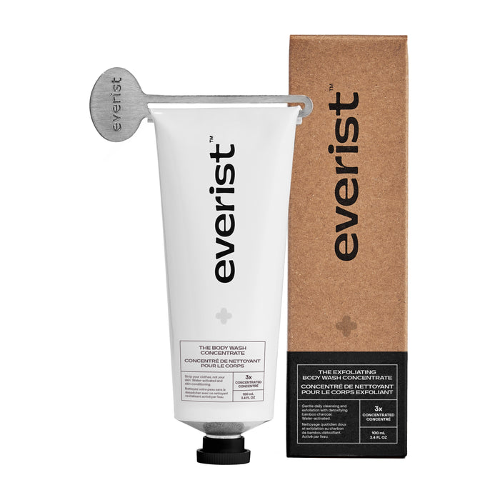 A white tube labeled Everist with a metal key sits beside a brown box featuring The Exfoliating Body Wash Concentrate—an effective body care product enriched with skincare ingredients.