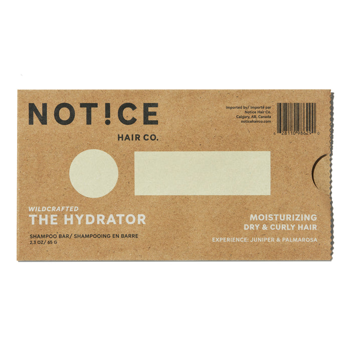 NOT!CE Hair Cos The Hydrator Shampoo Bar comes in brown cardboard packaging, designed to moisturize dry and curly hair. This plastic-free option includes text about the juniper and palmarosa experience and a barcode.