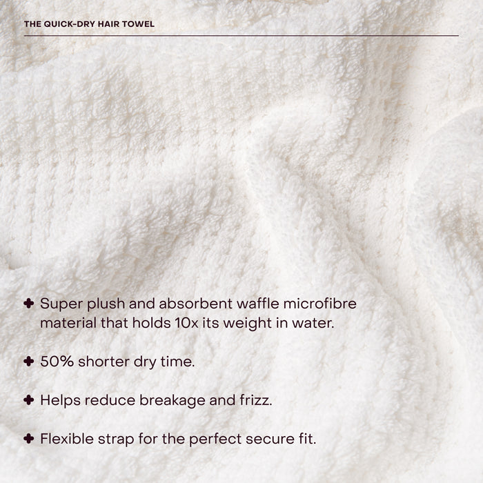 A close-up of The Quick-Dry Hair Towel by Everist, a soft, white waffle-textured microfiber towel thats highly absorbent, fast-drying to reduce frizz and breakage, and features a flexible strap for secure fit.