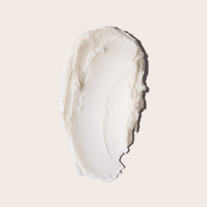A smooth, creamy white oval of Everist’s The Shampoo Concentrate Tin—rich in natural rosemary oil—rests on a light beige background, its thick whipped texture resembling premium skincare.