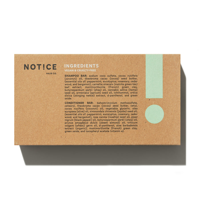 The Stimulator Travel Set by NOT!CE Hair Co comes in a light brown cardboard box with mint green accents and an exclamation mark, highlighting INGREDIENTS for vegan, cruelty-free shampoo and conditioner bars featuring French green clay.