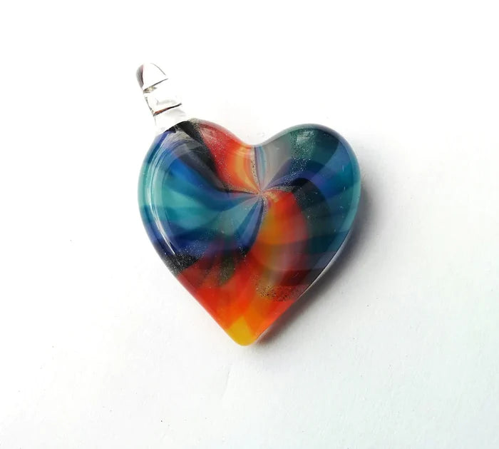 Heart shaped glass pendant with vibrant tie dye swirls on a chain