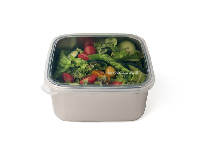 The U-Konserve To-Go Large Container is an eco-friendly stainless steel container with a clear, silicone-topped lid, ideal for carrying fresh salads like lettuce, cherry tomatoes, cucumber slices, and green peppers. Perfect for sustainable meals on the go.