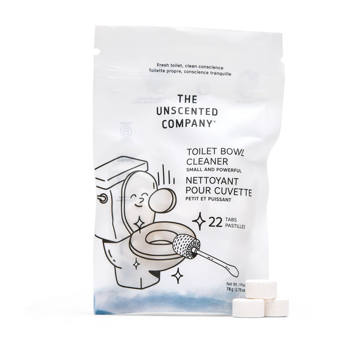 A white bag of The Unscented Company Toilet Bowl Cleaning Tabs, featuring an illustrated toilet and brush, contains 22 unscented tabs. Three white tabs are displayed in front, promoting sustainable hygiene.