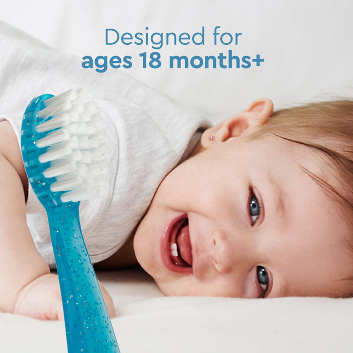 A smiling baby lies on their side next to a blue Radius Totz Toothbrush 18 mo+. Text above reads, Designed for ages 18 months+.