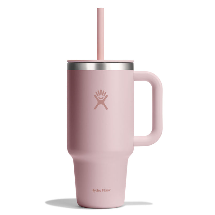 The 32 oz pink Hydro Flask Travel Tumbler features a handle, matching straw, leak-resistant lid, stainless steel rim, double-wall vacuum insulation, and sports the Hydro Flask logo in a sleek design.