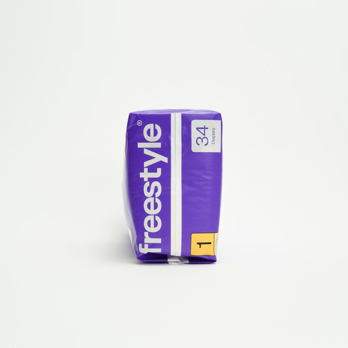 A purple Freestyle Tree Free Bamboo Diaper package stands upright, containing 34 eco-friendly diapers. A yellow area displays the number 1 for size. The background is plain white.