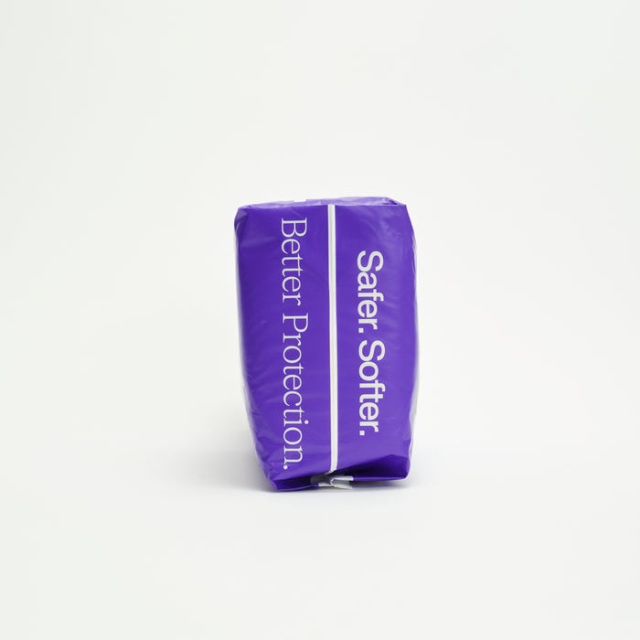 A rectangular, purple package of Freestyle Tree Free Bamboo Diaper stands upright on a white background, featuring "Safer. Softer." on the front and "Better Protection." on the side in white text.