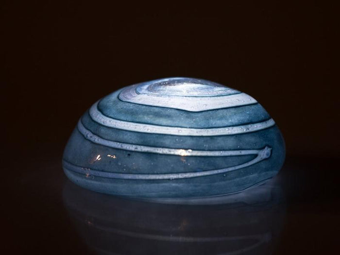 Turquoise votive memorial stone with layered white swirls designed to glow when lit by the LED tealight
