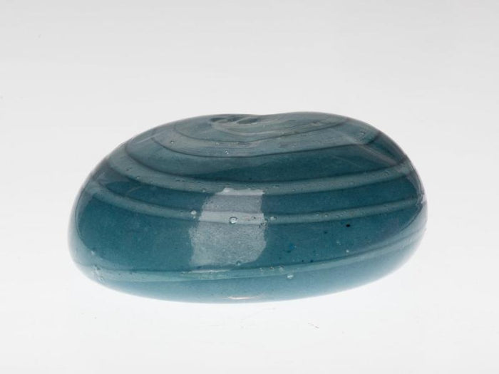 Turquoise hollow votive memorial stone with a cavity for an LED tealight, glowing softly when lit.