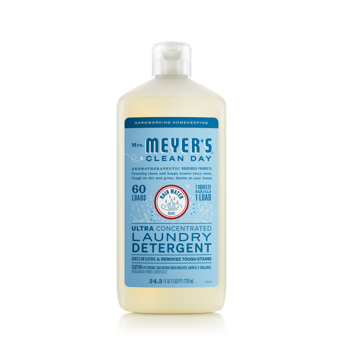 A 24 oz clear bottle of Mrs. Meyers Ultra Concentrated Liquid Laundry detergent in a lemon verbena scent claims 60 loads per bottle, featuring stain-fighting enzymes and essential oils for gentle cleaning.