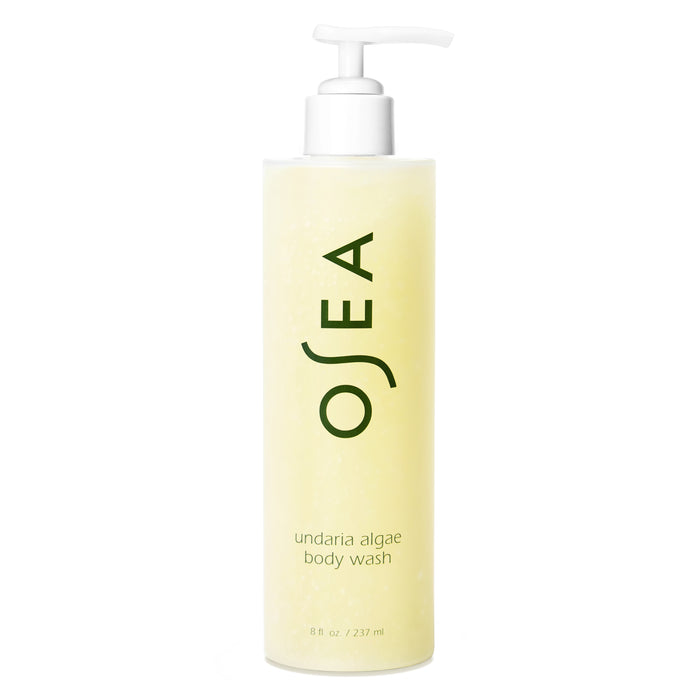 A pump bottle of OSEA Undaria Algae™ Body Wash with a pH-balanced, light yellow liquid. The label displays "OSEA" in large letters and product details, including the name Undaria Algae™ Body Wash, in smaller text below.