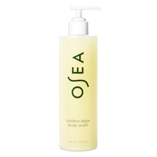 A pump bottle of OSEA Undaria Algae™ Body Wash with a pH-balanced, light yellow liquid. The label displays "OSEA" in large letters and product details, including the name Undaria Algae™ Body Wash, in smaller text below.