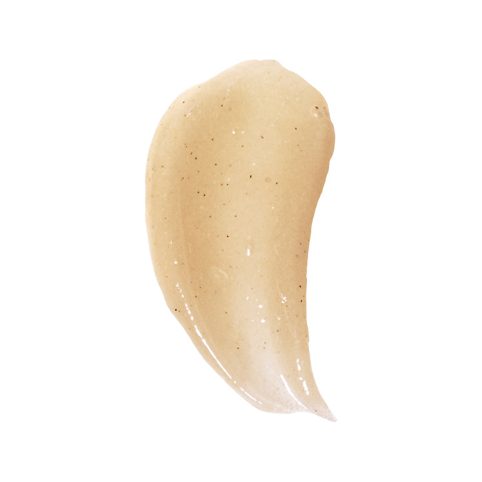 Close-up of a beige cream smear with dark specks on white, mirroring the texture of OSEAs Undaria Cleansing Body Polish, ideal for luxurious AHA exfoliation.