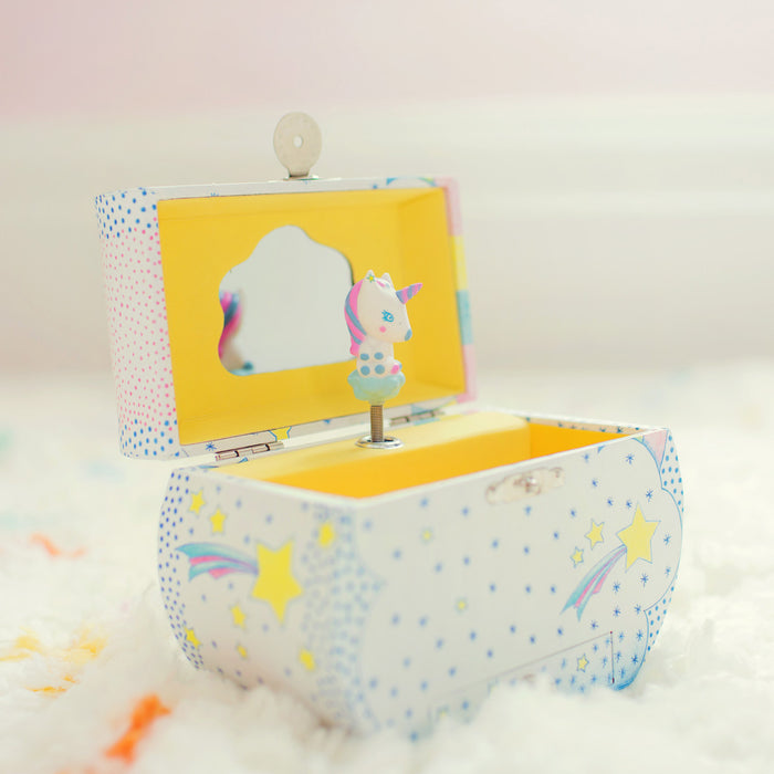 The DJECO Unicorn Dreams Musical Treasure Box features a starry, polka-dotted design and a whimsical unicorn figurine. Inside, an open lid reveals a mirror perfect for storing jewelry, resting on a soft white surface for a dreamy ambiance.