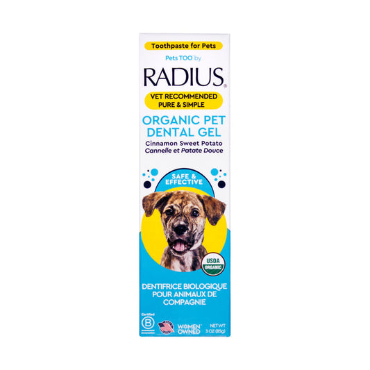 A box of Radius USDA Organic Canine Toothpaste with a dog image, cinnamon sweet potato flavor, English and French text, vet recommended, and USDA Organic certified.