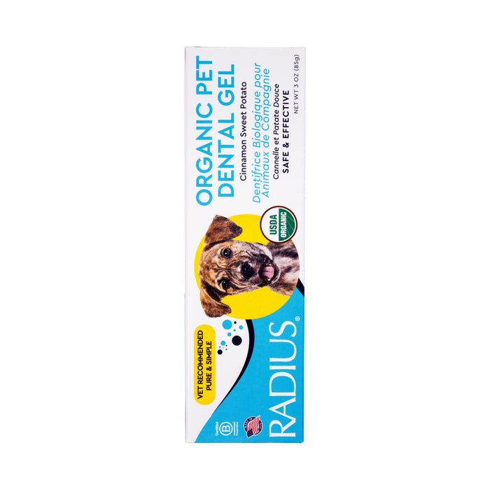 A box of Radius USDA Organic Canine Toothpaste with a happy dog, info in English and French, plus labels showing its vet-recommended and safe for your pet.