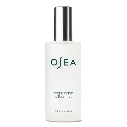 A frosted glass spray bottle with a silver cap labeled OSEA Vagus Nerve Pillow Mist holds 3.4 fl oz (100 ml) and is designed to promote relaxation before sleep.