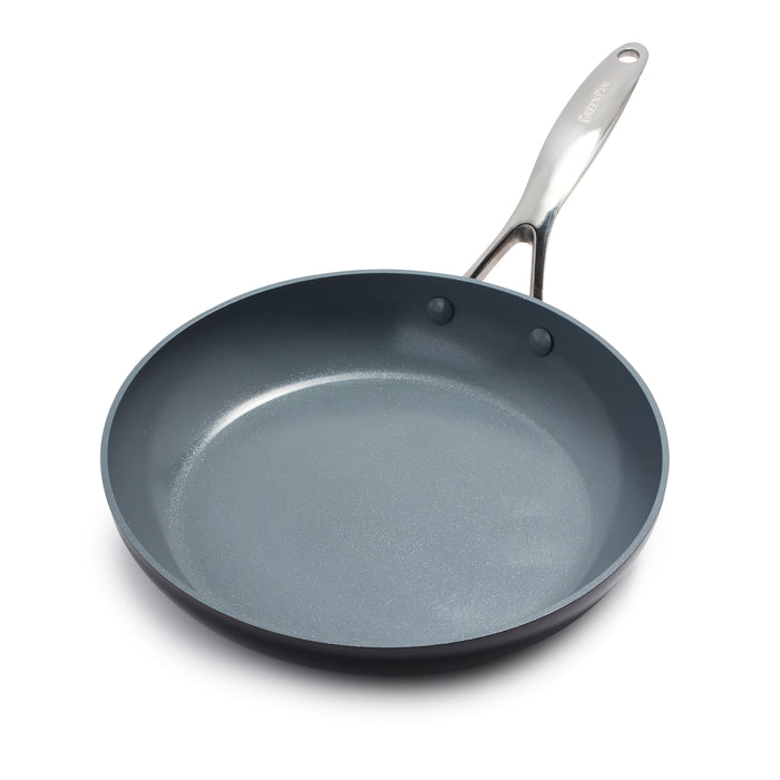 The GreenPan Valencia Pro Ceramic Nonstick Fry Pan, crafted from hard anodized aluminum, features a shiny silver handle angled to the right. Its dark gray coating ensures even cooking on a white surface and is PFAS-free for safe culinary adventures.