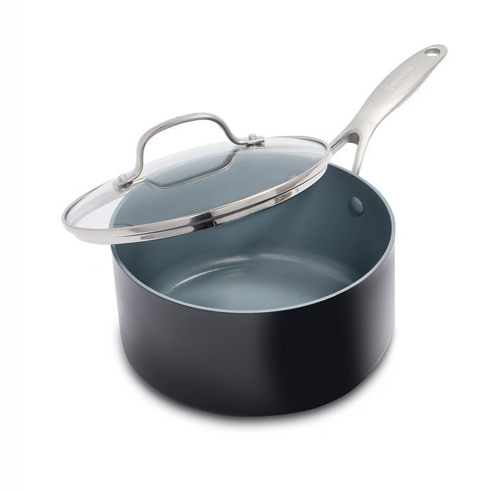GreenPans Valencia Pro Nonstick Sauce Pan, 2qt, features a sleek black exterior with a light grey ceramic nonstick PFAS-Free interior and a stainless steel handle. It comes with a matching glass lid for an elegant design.