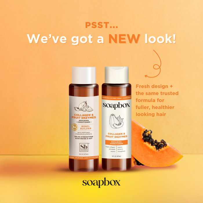 Two bottles of Soapbox Vegan Collagen & Fruit Enzymes Strengthening Conditioner on an orange backdrop. Text reads, PSST... Weve got a NEW look! with a papaya slice nearby, highlighting the fresh design and enriched formula for healthier hair.