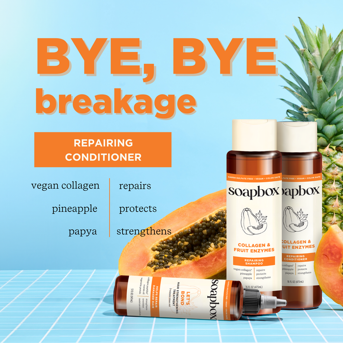 Soapbox Vegan Collagen & Fruit Enzymes Strengthening Conditioner bottles sit on blue tiles next to halved papaya and pineapple, emphasizing benefits like repair and strength with a vitamin complex and collagen peptides for healthier hair.