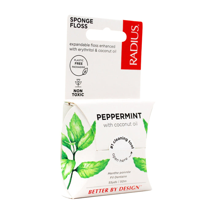 A white box of Radius Vegan Floss with coconut oil, featuring green mint leaves on plastic-free packaging and labeled as non-toxic and better by design.