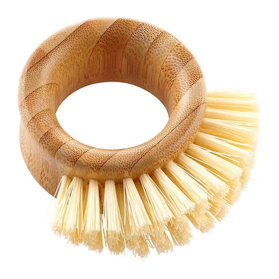The Full Circle Veggie Brush is a round, wooden scrub brush with stiff, recycled bristles from one side. It has an open center and a polished finish showcasing natural wood grain patterns—perfect for your kitchen.