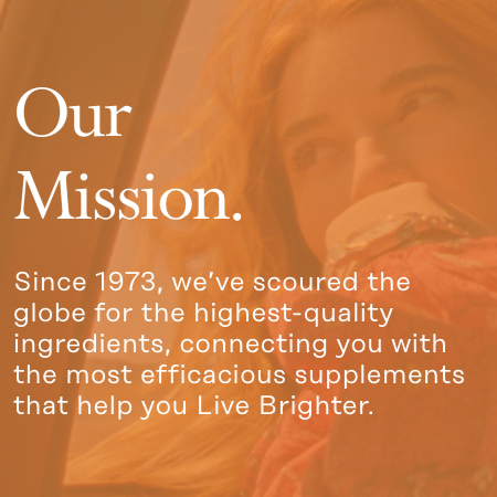 A woman smiling and taking a bite of a sandwich is partially visible through a golden filter. Text overlays read: "Our Mission. Since 1973, we’ve scoured the globe for the highest-quality ingredients, connecting you with the most efficacious supplements that help you Live Brighter.
