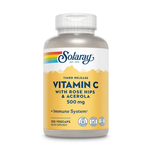 A bottle of Solaray Vitamin C Timed Release with Rose Hips & Acerola, 500 mg, has a yellow label with a rainbow stripe featuring Timed Release and Immune System. It contains 250 vegcaps and includes dietary supplement icons for optimal health support.