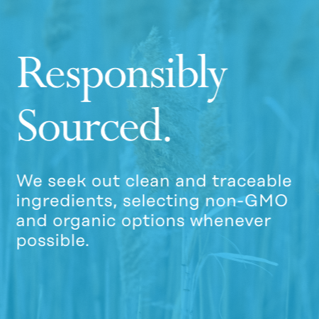 Text over an image of a blue-tinted wheat field. The text reads: "Responsibly Sourced. We seek out clean and traceable ingredients, selecting non-GMO and organic options whenever possible.