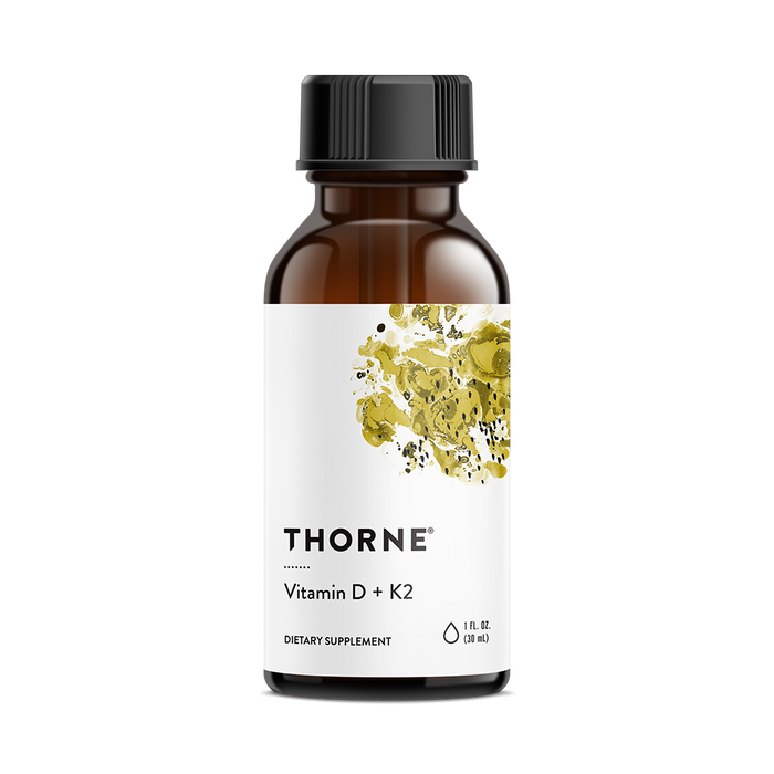A brown glass bottle labeled with the brand name Thorne and product name Vitamin D + K2 features a white label with abstract yellow and black artwork. This 1 fl oz (30 ml) dietary supplement is formulated for immune support, combining vitamins D and K to enhance wellness.