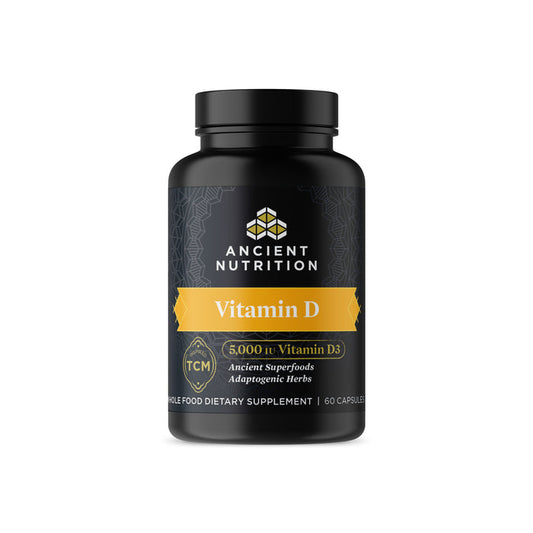 A black bottle from Ancient Nutrition, labeled Ancient Nutrients - Vitamin D, features a yellow band with Vitamin D and 5,000 IU Vitamin D3. It includes adaptogenic herbs for immune support and contains 60 capsules to promote overall wellness.