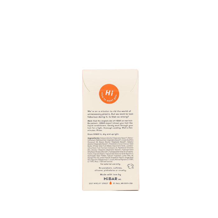 The back of a HiBAR package describes their mission to reduce plastic use with the Volumize Conditioner for fine hair. The beige packaging has an orange circle at the top, includes contact info at the bottom, and highlights ingredients that enhance body and volume.