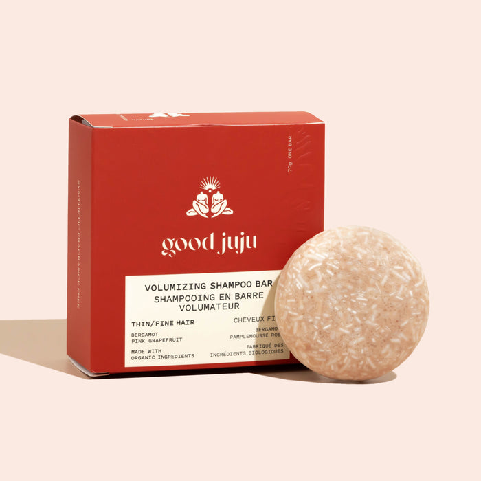 The Volumizing Shampoo Bar for Oily/Fine Hair by Good Juju Body & Home sits in front of its red box, featuring a pink grapefruit scent, organic ingredients, and promoting natural hair growth for thin or fine hair.