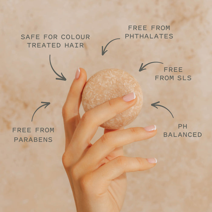 A hand holds Good Juju Body & Home’s Volumizing Shampoo Bar—pH balanced for oily/fine hair, supports natural growth, safe for colour-treated hair, and free from parabens, phthalates & SLS.