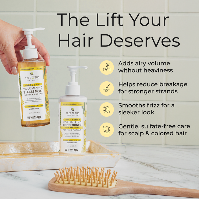 A hand dispenses Tree To Tub Thickening Collagen and Biotin Shampoo beside the matching conditioner on a bathroom counter with a wooden hairbrush. Benefits include volume, less breakage, smoother hair, and sulfate-free care.