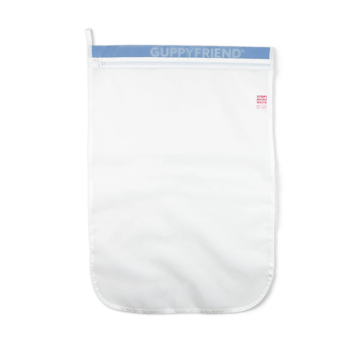 A GUPPYFRIEND Washing Bag, Prevent Microplastic Pollution, is displayed on a white background. This white bag has a blue top band and a zipper closure, designed to reduce microplastic pollution from washing synthetic textiles.