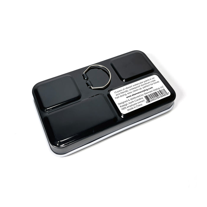 The Elseware Unplug Watercolor Set is housed in a rectangular black eco-friendly aluminum case with rounded corners, a silver center ring, and a white label featuring text and barcode—perfectly sized for travel, shown against a white background.