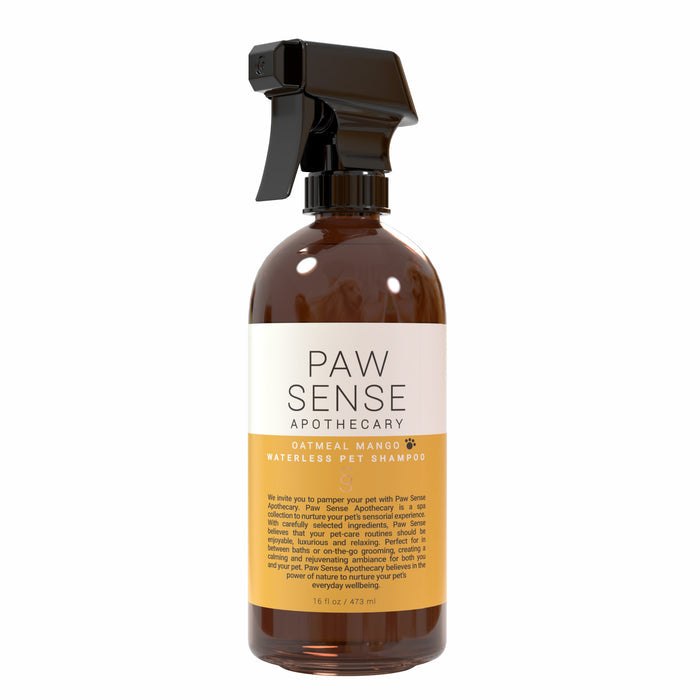 The 16 fl oz brown bottle of Paw Sense Waterless Pet Shampoo, naturally fragranced with oatmeal mango, features a black spray nozzle for easy dog and cat grooming. Its label has a description in smaller text.