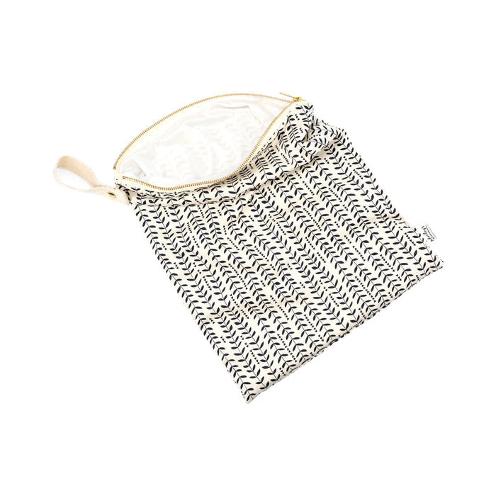 A partially open Marleys Monsters Wet Bag with a black and white fishbone pattern rests on a white background. Ideal for cloth diapering, it features a small loop handle for easy carrying.