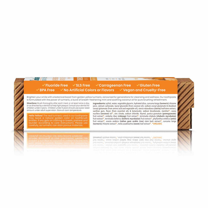 The box for Himalayas Whitening Antiplaque Turmeric + Coconut Oil Toothpaste highlights benefits like fluoride-free, SLS-free, carrageenan-free, gluten-free, BPA-free, no artificial colors or flavors, and vegan and cruelty-free. Enriched with neem for cleansing and turmeric & coconut oil for whitening. The box is reflective on the white surface.
