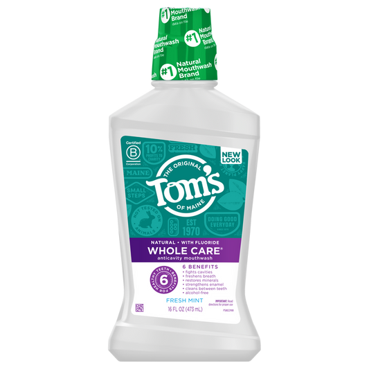 Toms of Maine Whole Care Anticavity Mouthwash offers 16 fl oz (473 mL) of alcohol-free freshness, featuring six benefits, fresh mint, and natural ingredients, as highlighted on its purple and white label.