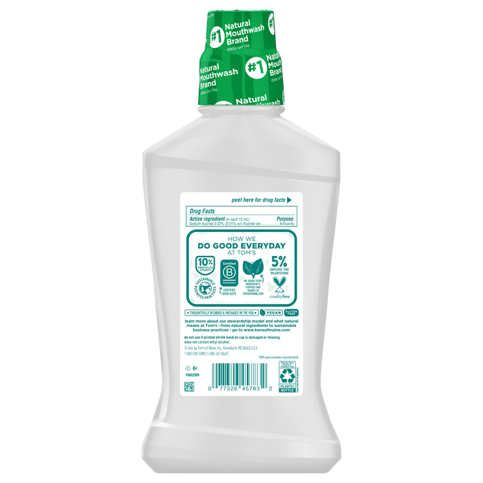 Toms of Maine Whole Care Anticavity Mouthwash features a sleek bottle with a green cap and detailed labeling that highlights its natural, alcohol-free formula along with the brand’s environmental initiatives, ingredients, and certifications. The packaging is mostly white with green accents.